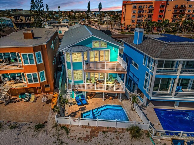 13303 Gulf Ln, Madeira Beach, FL 33708 - back of property featuring a fenced backyard and an outdoor pool