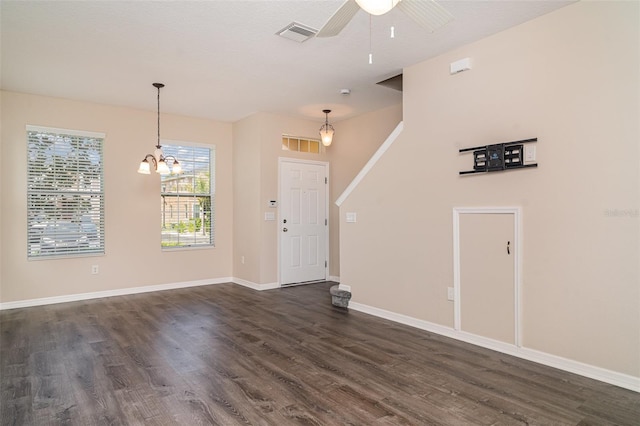 6920 Towering Spruce Dr, Riverview, FL 33578 - entrance foyer with dark wood-style flooring, ceiling fan, baseboards, and a chandelier