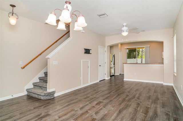 6920 Towering Spruce Dr, Riverview, FL 33578 - unfurnished living room featuring wood finished floors, ceiling fan, stairs, and a chandelier