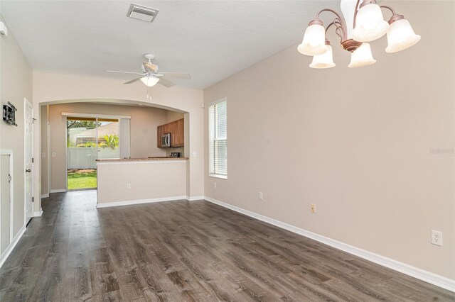 6920 Towering Spruce Dr, Riverview, FL 33578 - unfurnished living room featuring a chandelier, dark wood finished floors, and arched walkways