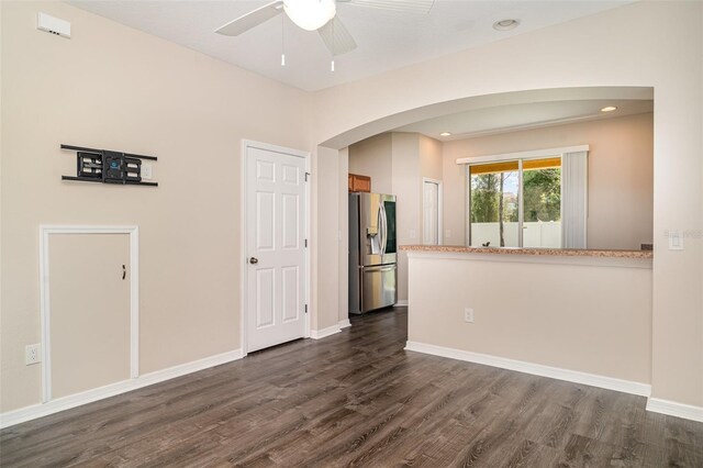 6920 Towering Spruce Dr, Riverview, FL 33578 - empty room featuring arched walkways, dark wood finished floors, ceiling fan, and baseboards