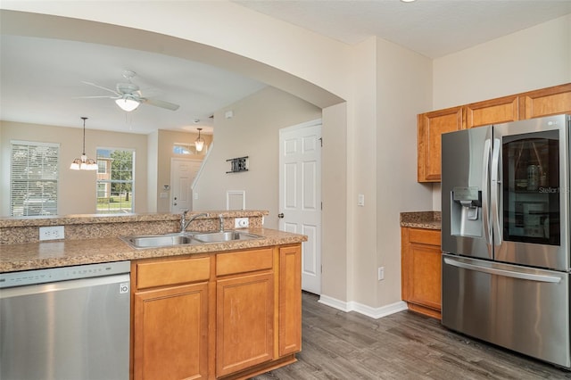6920 Towering Spruce Dr, Riverview, FL 33578 - kitchen with appliances with stainless steel finishes, a sink, dark wood-style flooring, ceiling fan, and arched walkways