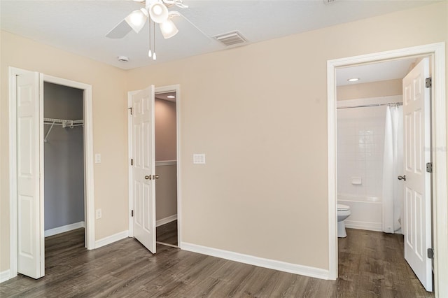 6920 Towering Spruce Dr, Riverview, FL 33578 - unfurnished bedroom with dark wood-style flooring, baseboards, and a closet