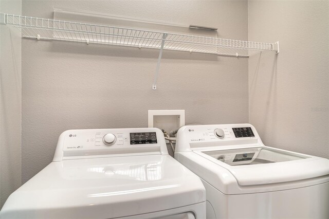 6920 Towering Spruce Dr, Riverview, FL 33578 - washroom featuring independent washer and dryer and a textured wall