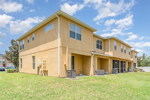 6920 Towering Spruce Dr, Riverview, FL 33578 - rear view of house with stucco siding, central AC unit, and a yard