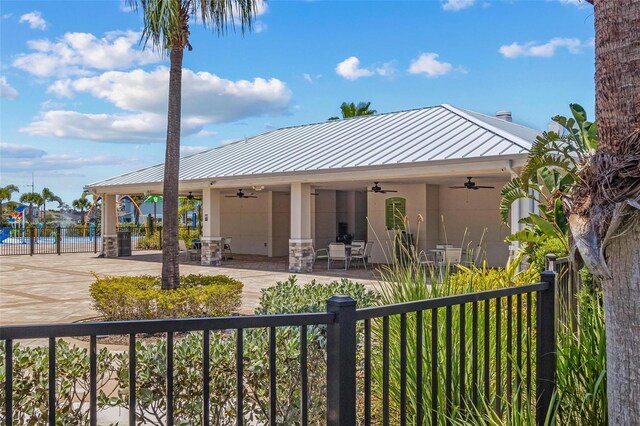 10945 High Noon Trl, Parrish, FL 34219 - rear view of property featuring a ceiling fan, a standing seam roof, and metal roof