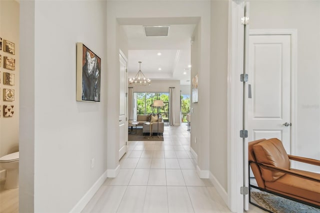 10036 Beachwalk Dr, Englewood, FL 34223 - corridor featuring baseboards, a chandelier, light tile patterned floors, a raised ceiling, and recessed lighting