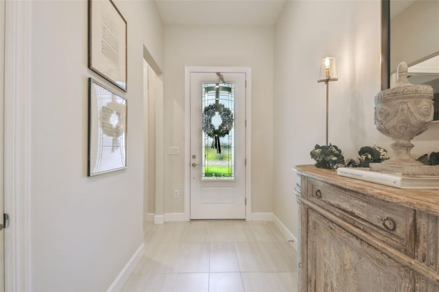 10036 Beachwalk Dr, Englewood, FL 34223 - foyer featuring light tile patterned floors and baseboards