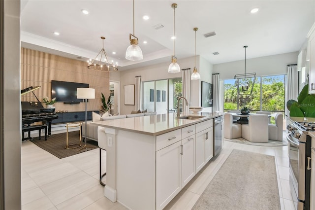 10036 Beachwalk Dr, Englewood, FL 34223 - kitchen with a sink, appliances with stainless steel finishes, an island with sink, open floor plan, and light countertops