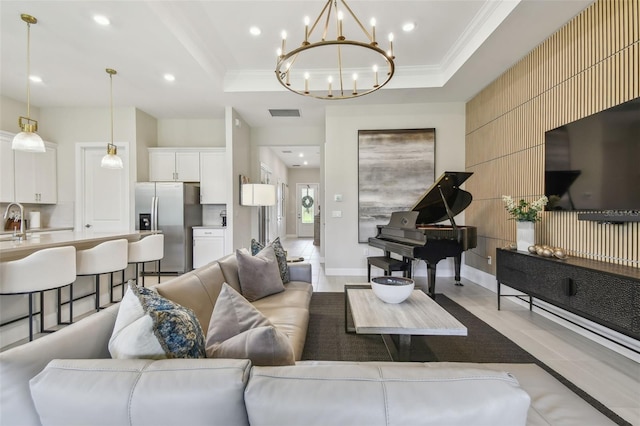 10036 Beachwalk Dr, Englewood, FL 34223 - living room with crown molding, recessed lighting, a chandelier, a raised ceiling, and light tile patterned flooring