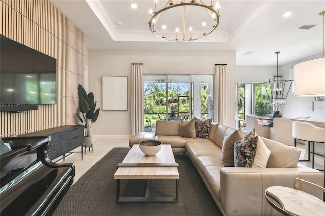10036 Beachwalk Dr, Englewood, FL 34223 - living area featuring a chandelier, ornamental molding, a tray ceiling, recessed lighting, and baseboards