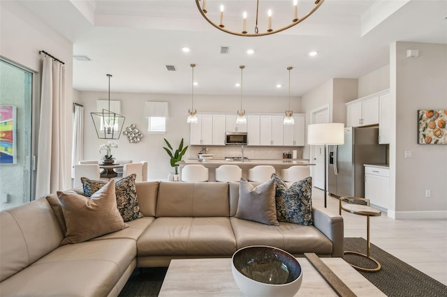 10036 Beachwalk Dr, Englewood, FL 34223 - living area featuring a chandelier, recessed lighting, baseboards, and crown molding