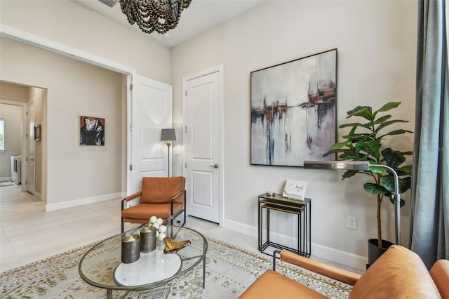 10036 Beachwalk Dr, Englewood, FL 34223 - living area featuring a chandelier and baseboards