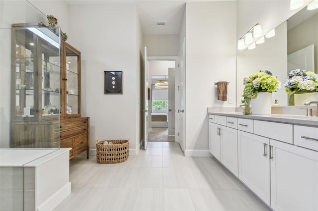 10036 Beachwalk Dr, Englewood, FL 34223 - full bathroom featuring baseboards, vanity, and tile patterned floors