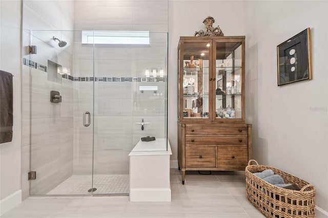 10036 Beachwalk Dr, Englewood, FL 34223 - full bath with a shower stall, tile patterned floors, and baseboards