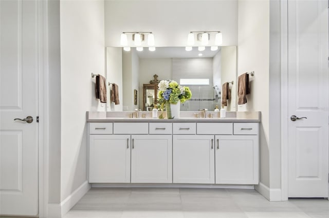 10036 Beachwalk Dr, Englewood, FL 34223 - full bathroom with double vanity, baseboards, tiled shower, and tile patterned flooring
