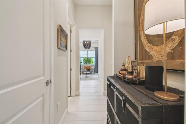 10036 Beachwalk Dr, Englewood, FL 34223 - corridor featuring light tile patterned floors and baseboards