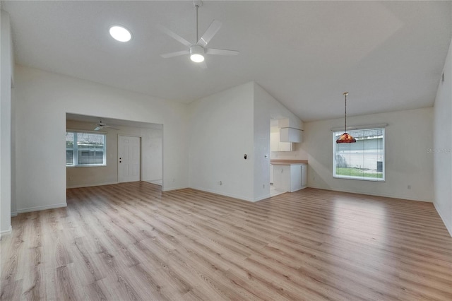 746 Masterpiece Dr, Sun City Center, FL 33573 - unfurnished living room featuring a ceiling fan, lofted ceiling, light wood-style floors, and baseboards