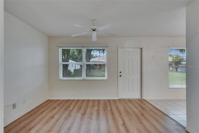 746 Masterpiece Dr, Sun City Center, FL 33573 - foyer with plenty of natural light, wood finished floors, baseboards, and a textured ceiling
