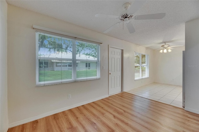 746 Masterpiece Dr, Sun City Center, FL 33573 - entrance foyer featuring wood finished floors, ceiling fan, a textured ceiling, and baseboards