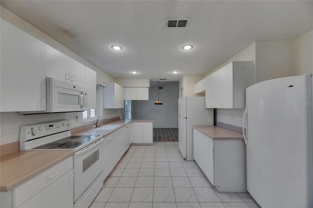 746 Masterpiece Dr, Sun City Center, FL 33573 - kitchen with white appliances, a sink, white cabinetry, light countertops, and recessed lighting
