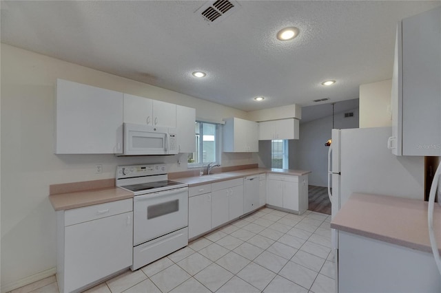 746 Masterpiece Dr, Sun City Center, FL 33573 - kitchen featuring white appliances, light countertops, a sink, white cabinets, and recessed lighting