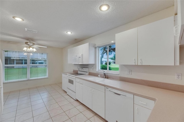 746 Masterpiece Dr, Sun City Center, FL 33573 - kitchen featuring white appliances, a sink, a textured ceiling, light countertops, and white cabinets