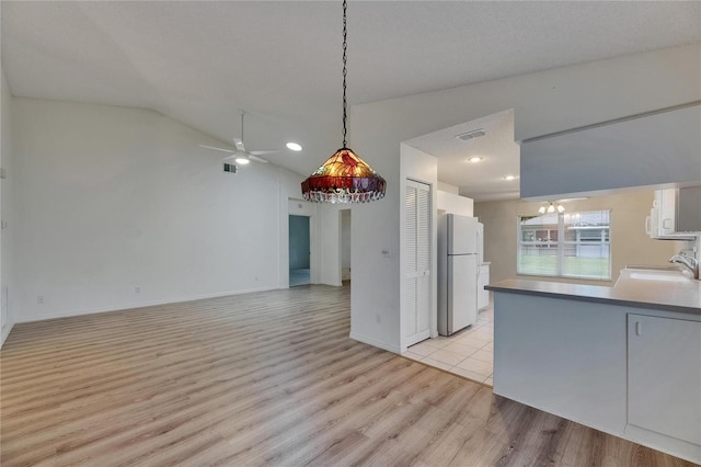 746 Masterpiece Dr, Sun City Center, FL 33573 - kitchen featuring freestanding refrigerator, a sink, light wood-type flooring, vaulted ceiling, and ceiling fan