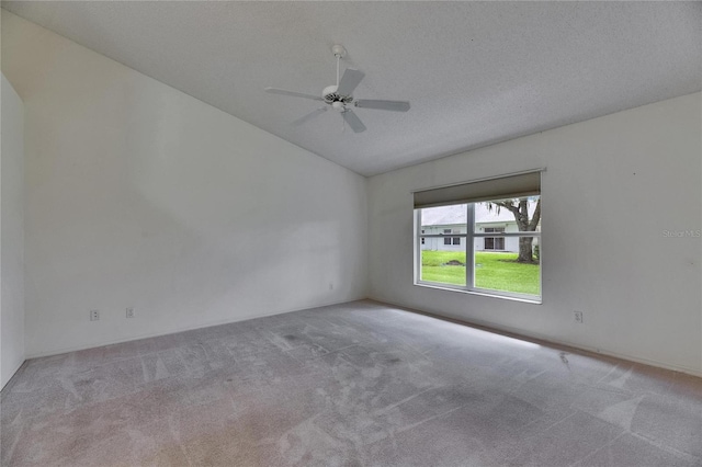746 Masterpiece Dr, Sun City Center, FL 33573 - carpeted empty room with vaulted ceiling and a ceiling fan