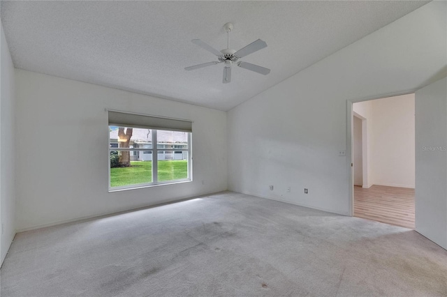 746 Masterpiece Dr, Sun City Center, FL 33573 - empty room featuring vaulted ceiling, carpet flooring, and a ceiling fan