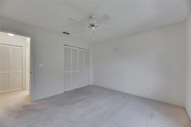 746 Masterpiece Dr, Sun City Center, FL 33573 - unfurnished bedroom with carpet flooring, a closet, ceiling fan, and a textured ceiling