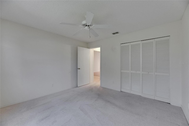 746 Masterpiece Dr, Sun City Center, FL 33573 - unfurnished bedroom with light colored carpet, a closet, and a ceiling fan