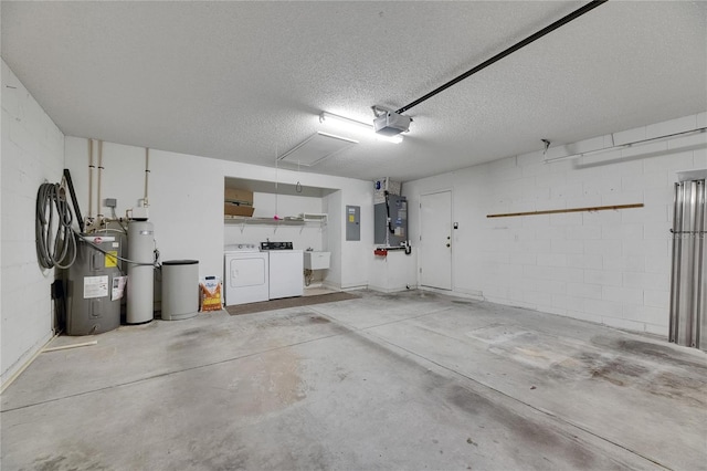 746 Masterpiece Dr, Sun City Center, FL 33573 - garage featuring water heater, independent washer and dryer, concrete block wall, a garage door opener, and a sink