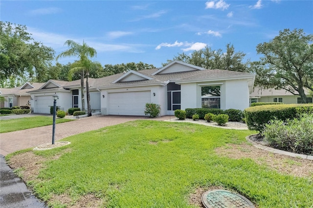 746 Masterpiece Dr, Sun City Center, FL 33573 - ranch-style house with a garage, decorative driveway, stucco siding, and a front yard