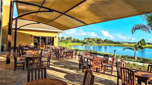 746 Masterpiece Dr, Sun City Center, FL 33573 - view of patio / terrace featuring a water view and outdoor dining space
