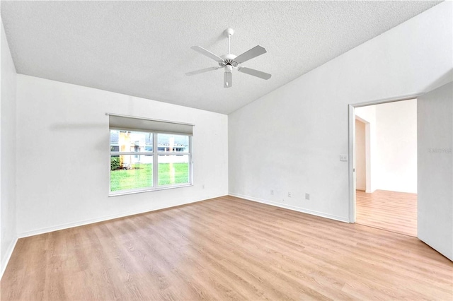 746 Masterpiece Dr, Sun City Center, FL 33573 - unfurnished room with vaulted ceiling, a textured ceiling, wood finished floors, and ceiling fan