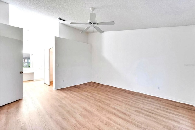 746 Masterpiece Dr, Sun City Center, FL 33573 - empty room featuring light wood-style floors, a ceiling fan, and a textured ceiling