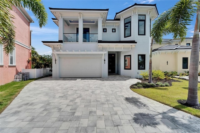 6520 Simone Shores Cir, Apollo Beach, FL 33572 - view of front of house featuring a balcony, stucco siding, an attached garage, and decorative driveway