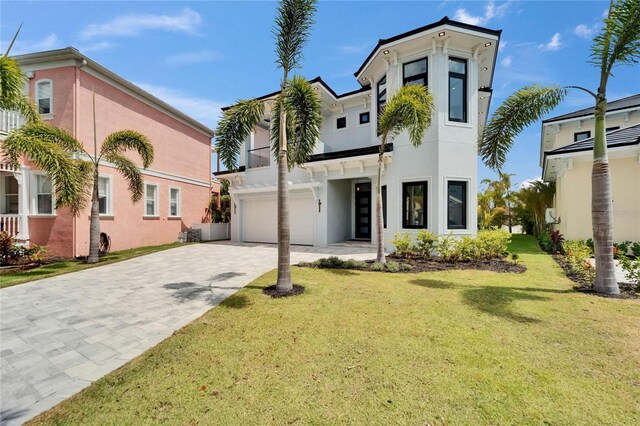 6520 Simone Shores Cir, Apollo Beach, FL 33572 - view of front facade featuring stucco siding, decorative driveway, a garage, and a front lawn