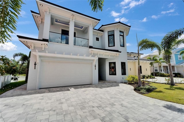 6520 Simone Shores Cir, Apollo Beach, FL 33572 - view of front of home featuring a balcony, stucco siding, an attached garage, driveway, and a front yard