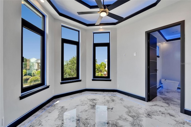 6520 Simone Shores Cir, Apollo Beach, FL 33572 - empty room with a tray ceiling, marble tiled floors, baseboards, and a ceiling fan