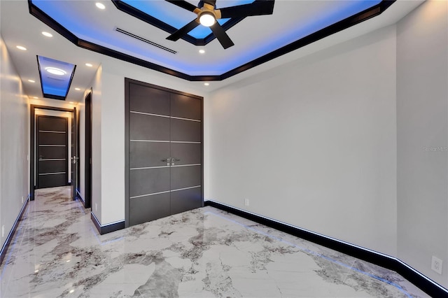 6520 Simone Shores Cir, Apollo Beach, FL 33572 - unfurnished bedroom with a tray ceiling, baseboards, light marble finish flooring, recessed lighting, and ornamental molding