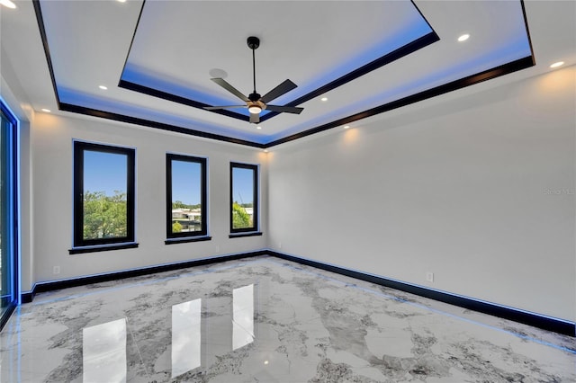 6520 Simone Shores Cir, Apollo Beach, FL 33572 - unfurnished room with a tray ceiling, a ceiling fan, marble tiled flooring, baseboards, and recessed lighting