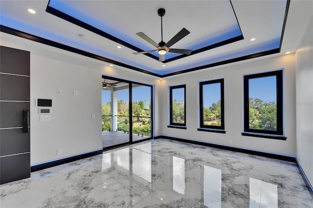 6520 Simone Shores Cir, Apollo Beach, FL 33572 - unfurnished room with a raised ceiling, a ceiling fan, marble tiled floors, baseboards, and recessed lighting