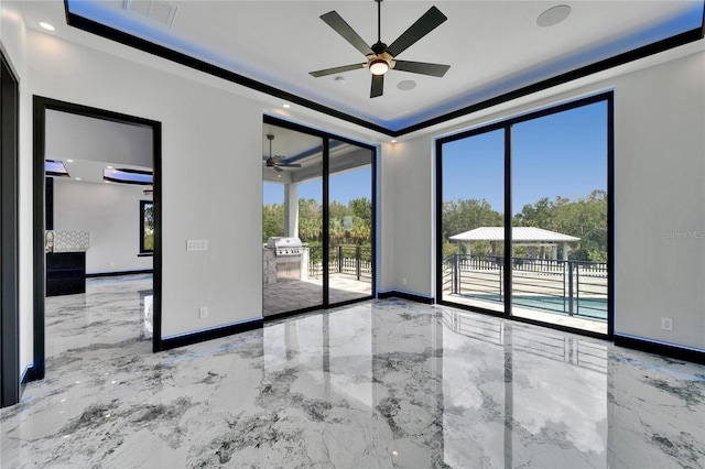 6520 Simone Shores Cir, Apollo Beach, FL 33572 - empty room with ceiling fan, marble tiled floors, a raised ceiling, and recessed lighting