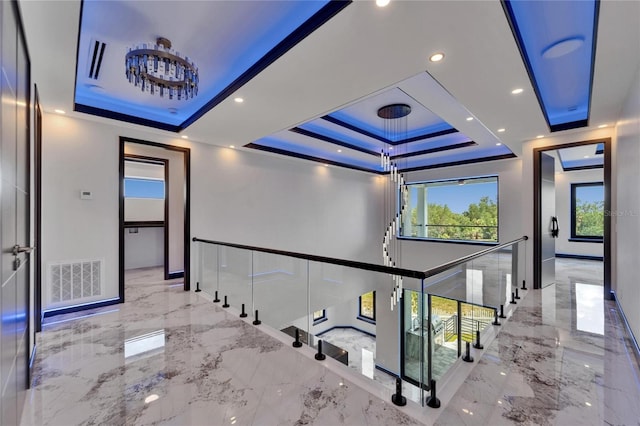 6520 Simone Shores Cir, Apollo Beach, FL 33572 - hallway with a tray ceiling, marble tiled floors, an upstairs landing, recessed lighting, and baseboards