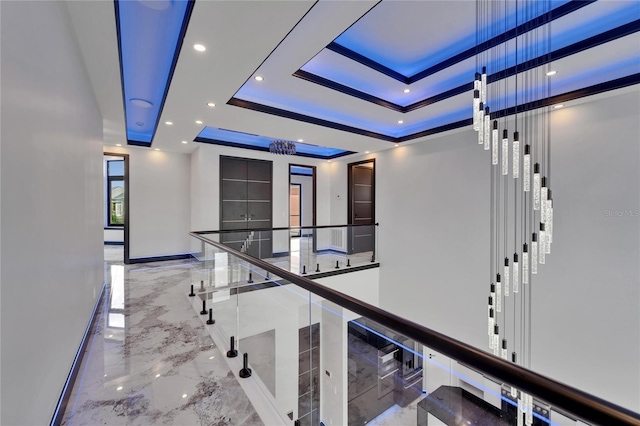 6520 Simone Shores Cir, Apollo Beach, FL 33572 - hallway with marble tiled flooring, a raised ceiling, recessed lighting, elevator, and baseboards