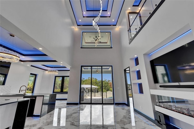 6520 Simone Shores Cir, Apollo Beach, FL 33572 - interior space featuring marble tiled floors, a tray ceiling, baseboards, recessed lighting, and a sink