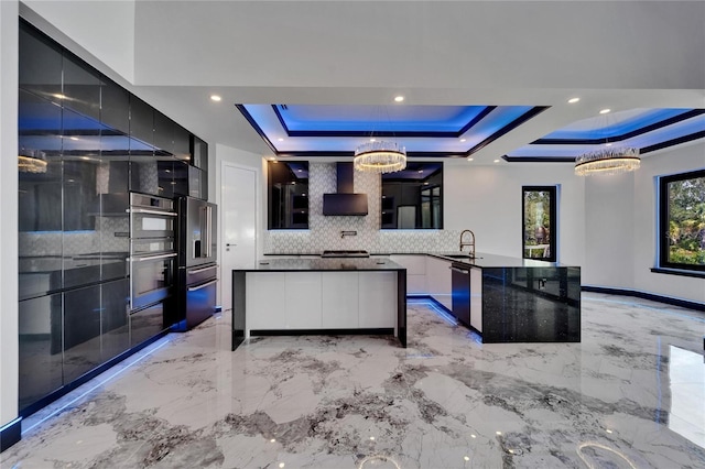 6520 Simone Shores Cir, Apollo Beach, FL 33572 - kitchen featuring modern cabinets, backsplash, a raised ceiling, stainless steel appliances, and light marble finish flooring