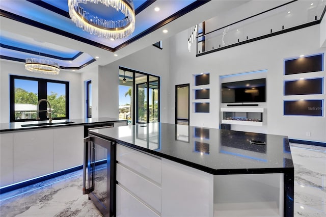 6520 Simone Shores Cir, Apollo Beach, FL 33572 - kitchen with light marble finish flooring, a sink, wine cooler, dark countertops, and recessed lighting